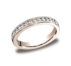 This elegant 3mm channel set eternity band features 36 round ideal-cut diamonds along the center with milgrain. Total approximate carat weight is .66ct.