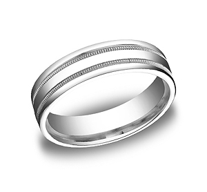 This Platinum 6mm comfort-fit carved design band features a high polished finish with milgrain and a round edge.