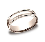 This 6mm comfort-fit carved design band features a high polished finish with milgrain and a round edge.